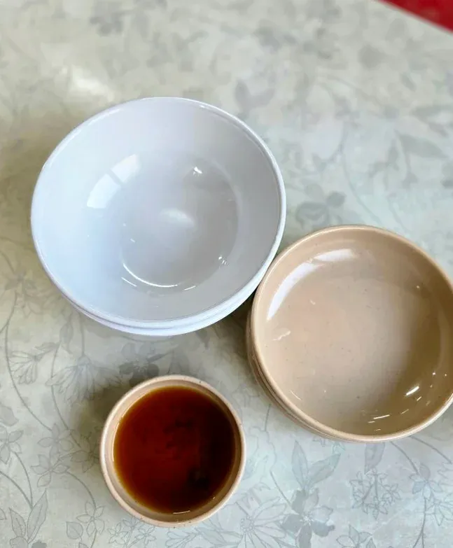 Empty bowls and a soy sauce dish prepared before a meal - Samcheongdong Sujebi: A Michelin-Recognized Taste of Traditional Korean Hand-Pulled Dough Soup in Seoul