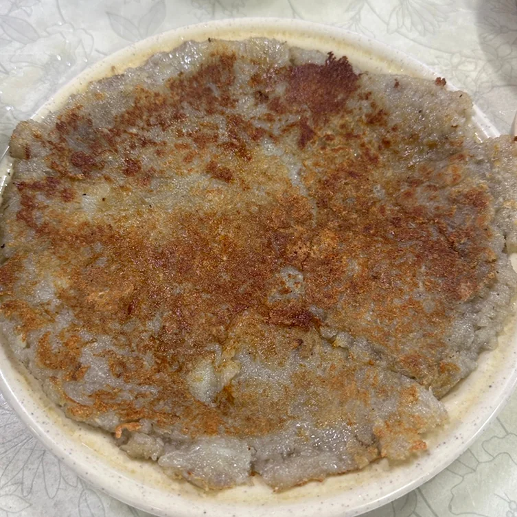 A perfectly cooked, crispy round potato pancake - Samcheongdong Sujebi: A Michelin-Recognized Taste of Traditional Korean Hand-Pulled Dough Soup in Seoul
