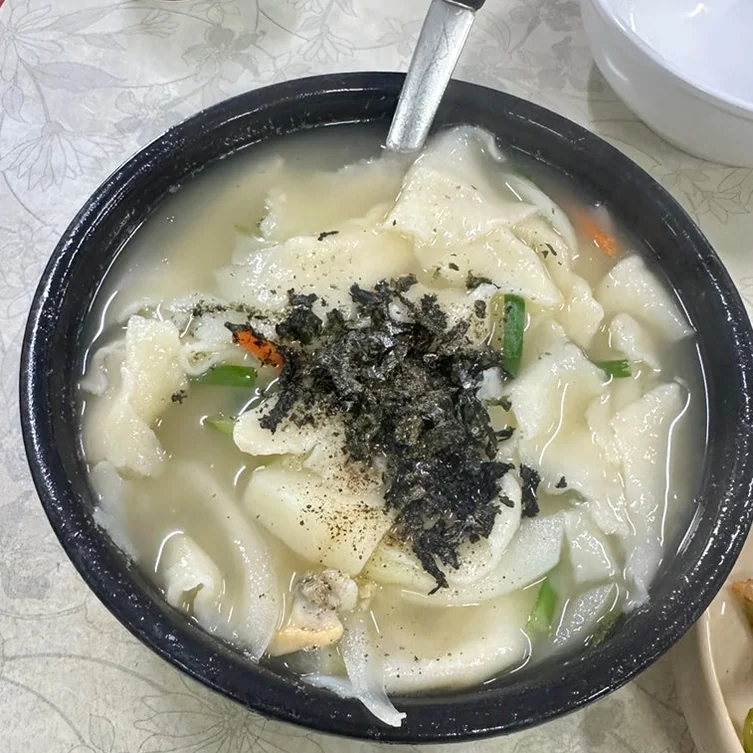 Hearty Samcheongdong Sujebi served in a rustic earthenware bowl - Samcheongdong Sujebi: A Michelin-Recognized Taste of Traditional Korean Hand-Pulled Dough Soup in Seoul