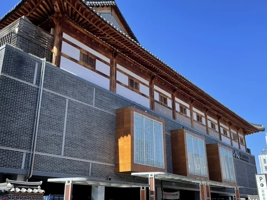 한옥 기와지붕과 고풍스러운 목조 구조가 돋보이는 박물관 건물 측면 전경. 전통과 현대가 어우러진 건축미가 인상적입니다. - ソウル薬令市韓医学博物館：五感で巡る、韓国伝統医療の魅力と癒し体験🌿