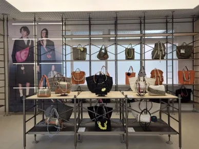 Interior view of Topologie store with various bags showcased on metal shelves and display tables - ソウルの森に誕生した Topologie 韓国初フラッグシップ：2026 SS ‘The Starbound’ の世界 🧭