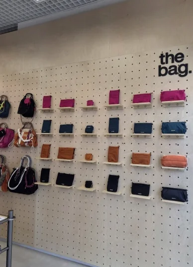 Wall display of Topologie bags and wallets with 'the bag.' text on a patterned pegboard wall - ソウルの森に誕生した Topologie 韓国初フラッグシップ：2026 SS ‘The Starbound’ の世界 🧭