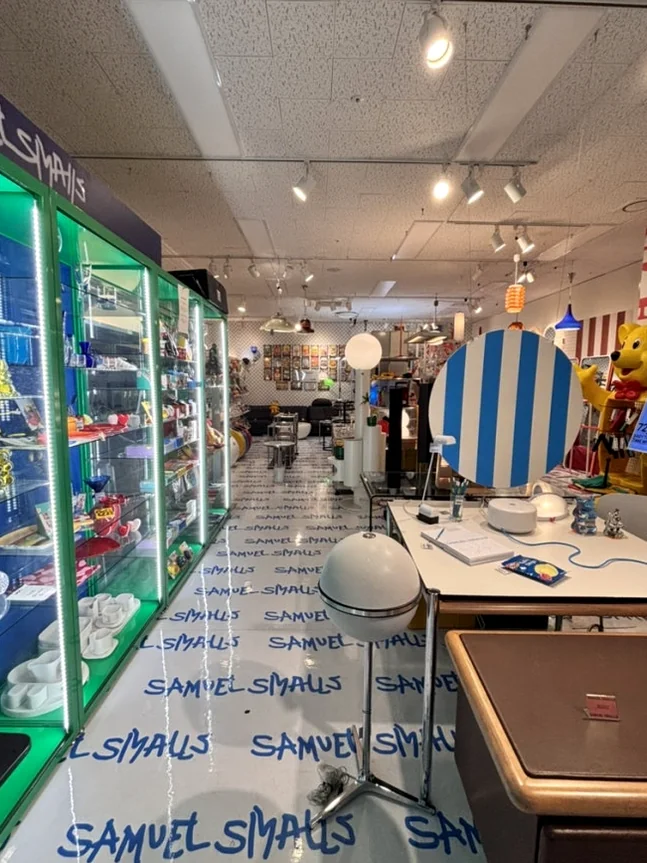 Interior view of the design shop with a blue and white striped table - A Masterclass in Mid-Century Curation: Navigating Samuel Smalls Seongsu Flagship