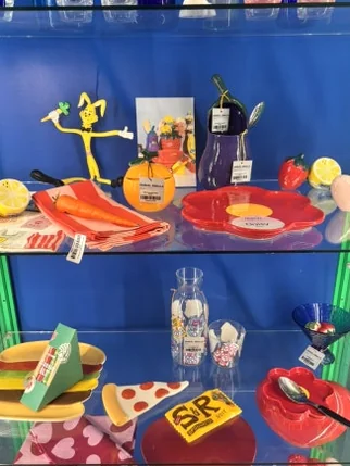 Glass display shelves containing colorful ceramic plates and food-shaped items - A Masterclass in Mid-Century Curation: Navigating Samuel Smalls Seongsu Flagship