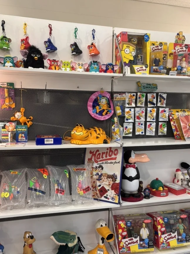 Vintage character toys and boxed collectibles displayed on white shelves - A Masterclass in Mid-Century Curation: Navigating Samuel Smalls Seongsu Flagship