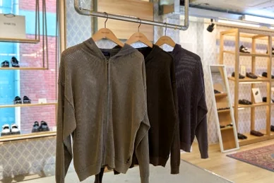 Knit hoodies in brown and dark tones displayed on hangers - 26SS Nautica Guide: Navigating the Hype Logistics at Worldwide Seoul Seongsu