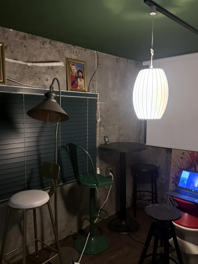 Interior with a white pendant light, high stools, and a projector screen. - A Cinematic Escape in Seongsu: The Deep Vibe Guide to Kumgyol Wine & LP Bar