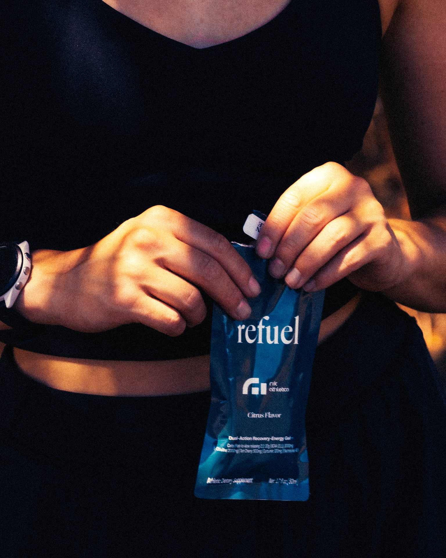Athlete tearing open Refuel gel