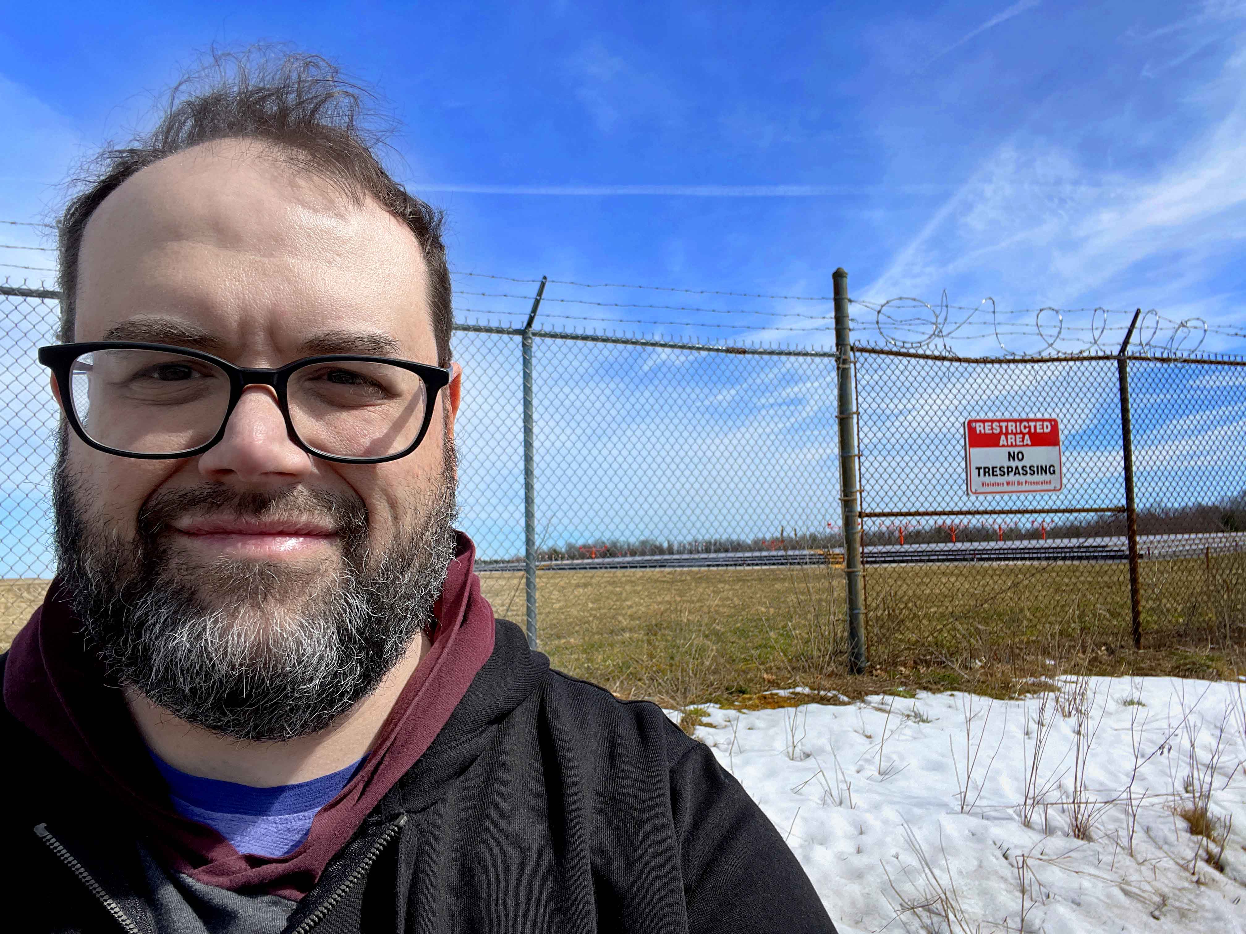 Professional headshot of Benjamin Oliver, Filmmaker, wearing glasses.