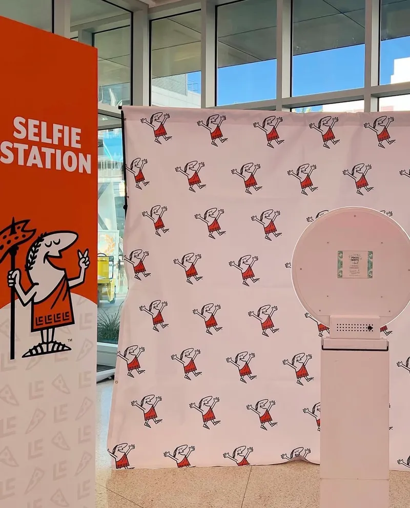 Corporate selfie station photo booth setup with branded backdrop