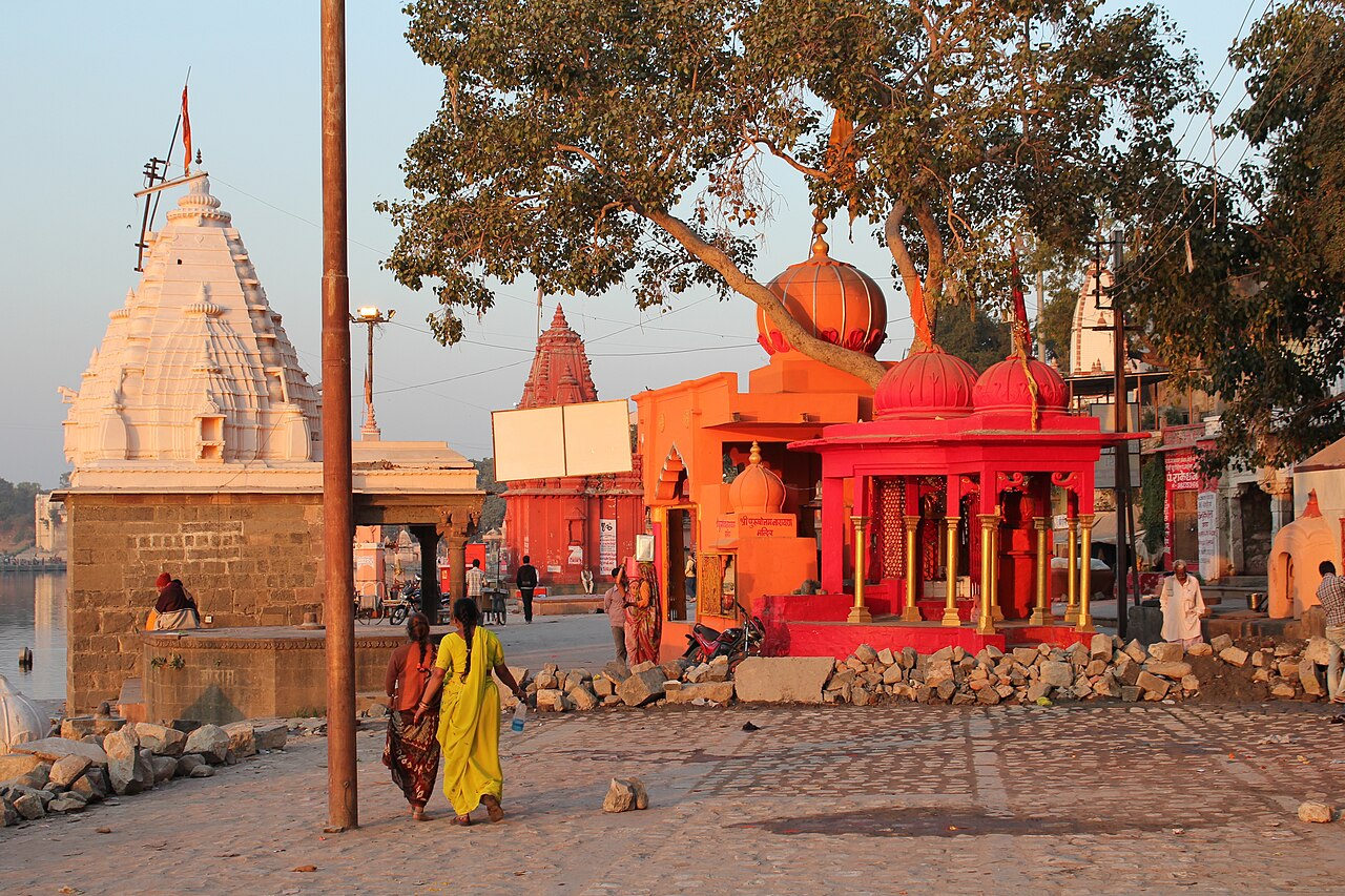 Temples and shrines on Ram Ghat beside the Shipra river in warm evening light, Ujjain