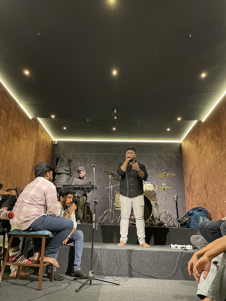 A singer performing to the room during a rehearsal