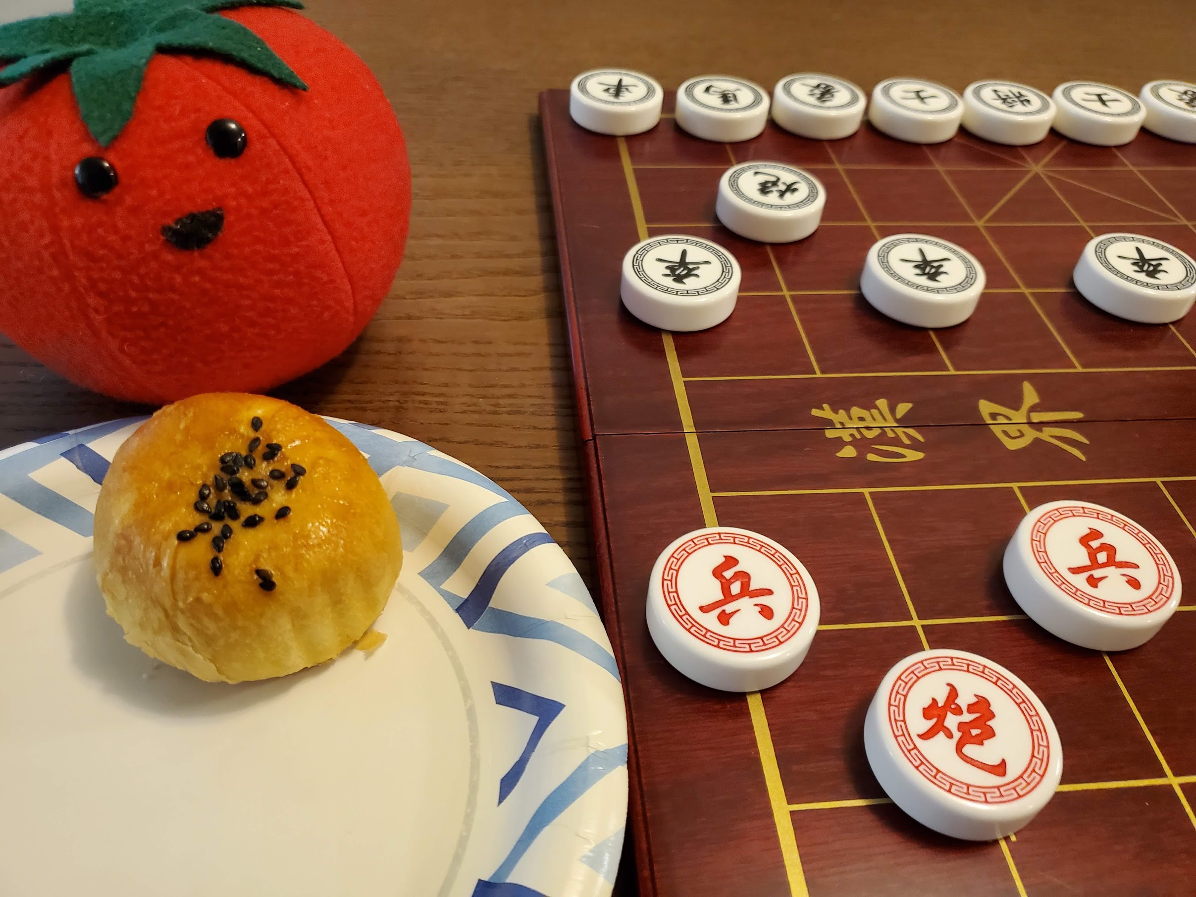 Mooncake placed next to set-up Xiangqi board