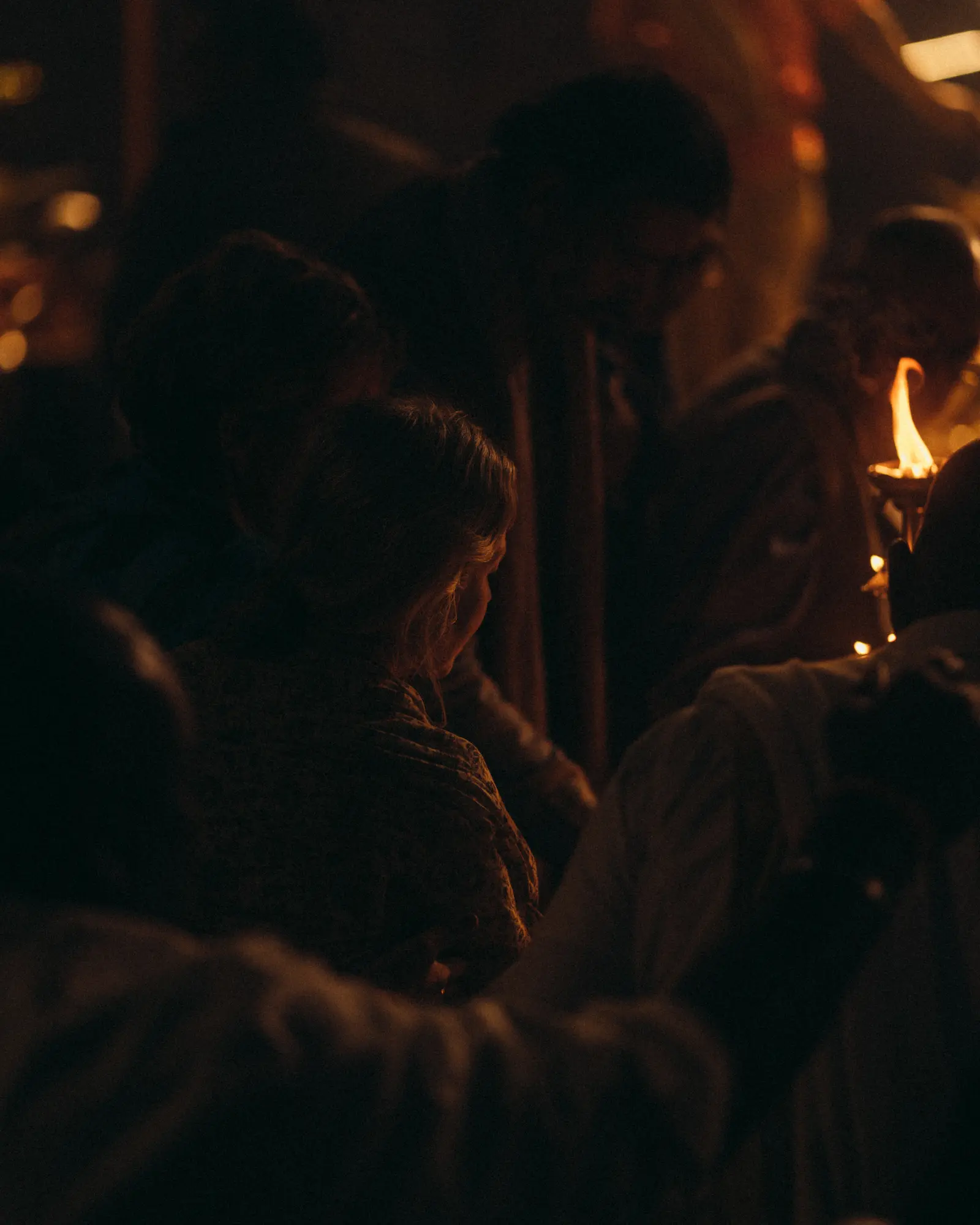 Woman lighting diya during Ganga Aarti