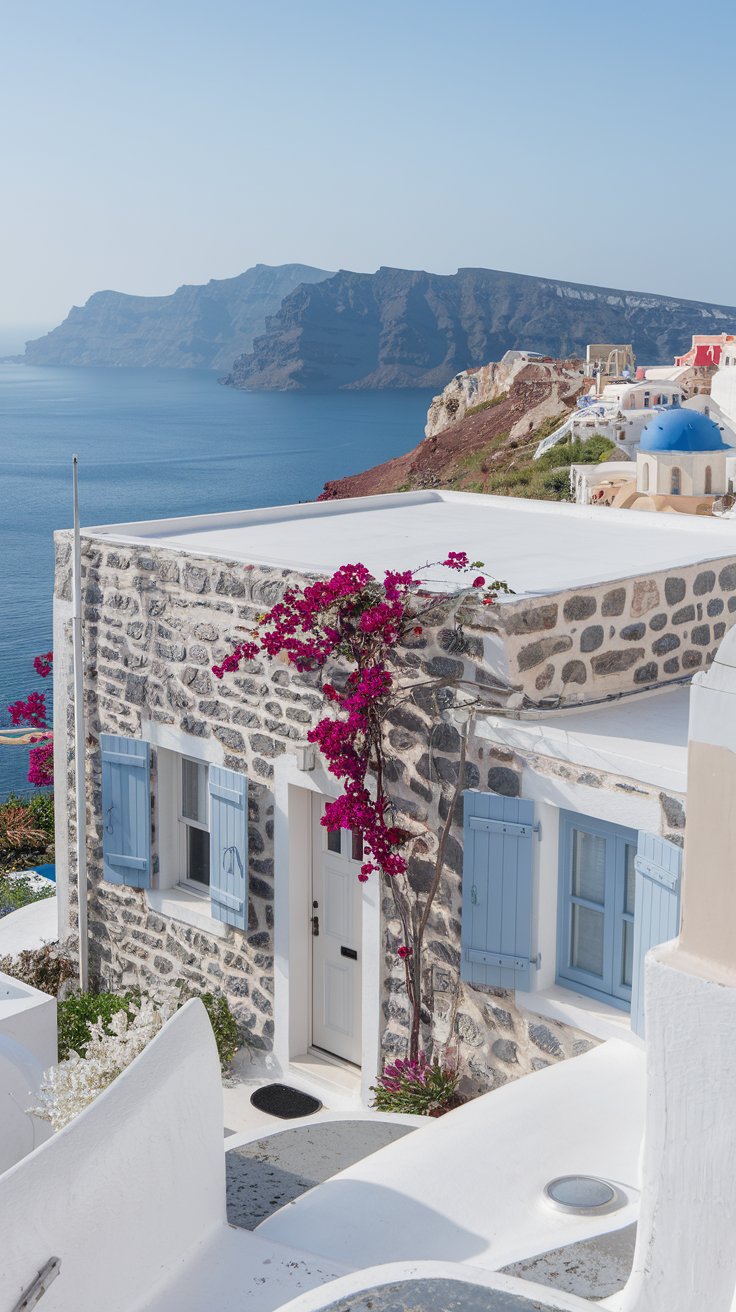 exterior, charming stone village house in Santorini, Greece, bright sunny day, flat white roof, white washed stone walls, blue wooden shutters and door, bougainvillea flowers climbing the walls
