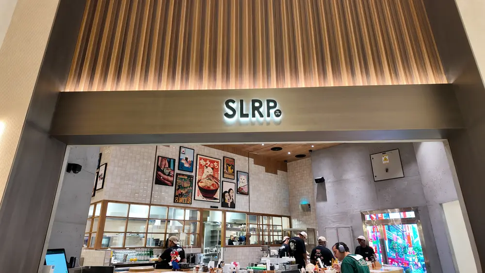 "Professionally-upholstered lounge chair in modern design, against a backdrop of polished marble and floor-to-ceiling windows, in a luxurious, sleek interior space for DWS Interiors, Dubai, UAE."