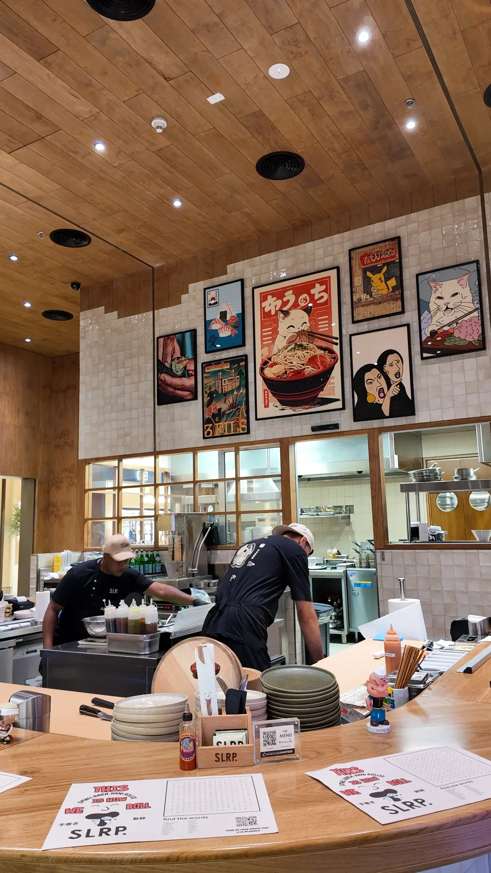 "Close-up of a modern, sleek DJI drone surrounded by interior design elements: a Natural stone wall, crimson cushions, and Arabesque patterns, suggesting a luxury fit-out in Dubai, UAE."