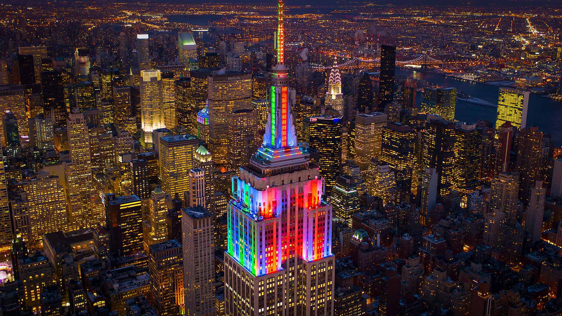 The Empire State Building lit up in honor of Pride Week in 2014, New York City - C. Taylor Crothers/Offset by Shutterstock)