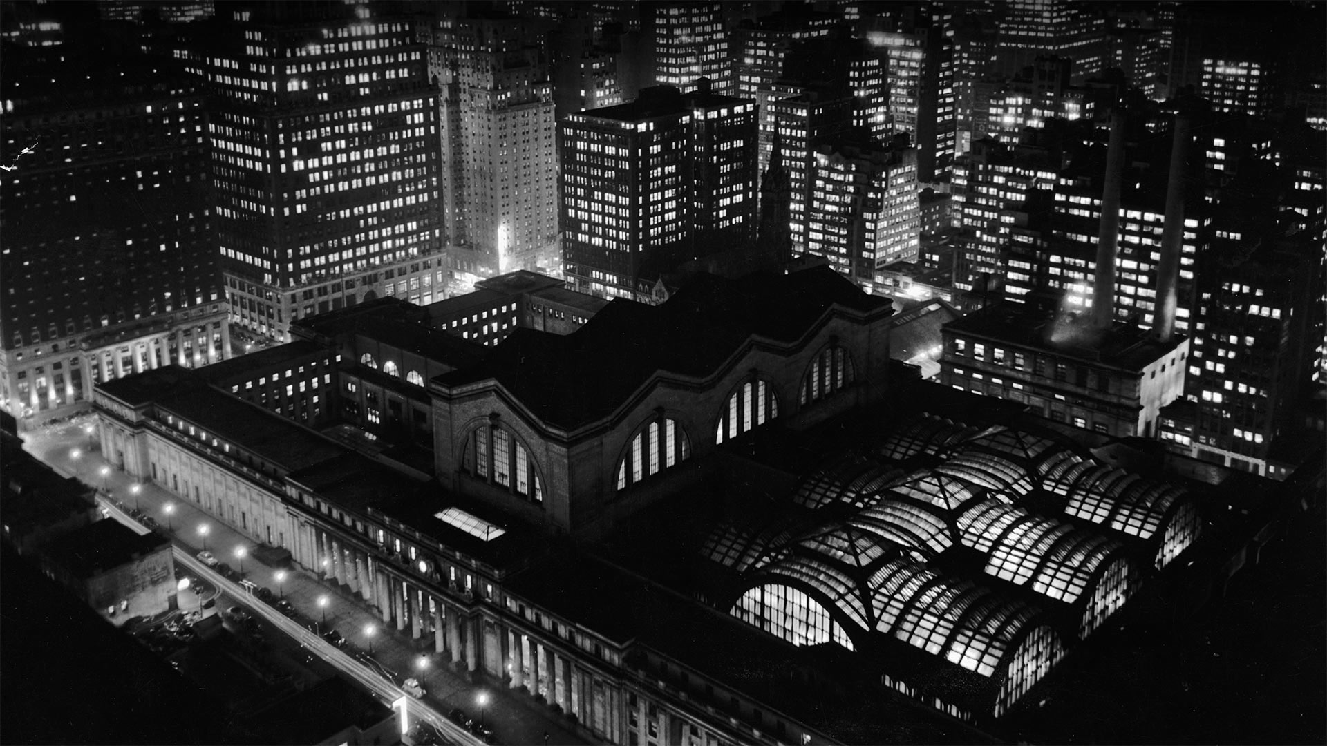 Aerial view of Penn Station and the New York City skyline at night in the 1950s - R. Gates -Staff/Getty Images)