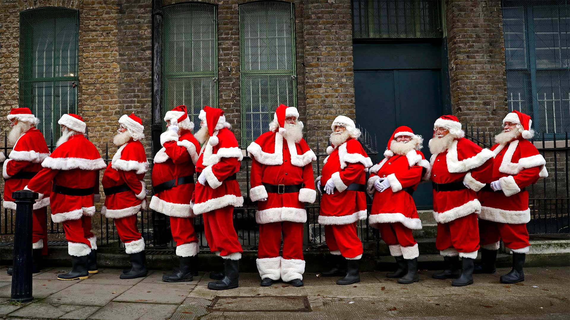 Performers from the Ministry of Fun Santa School in London, England - Matt Dunham/AP Photo)