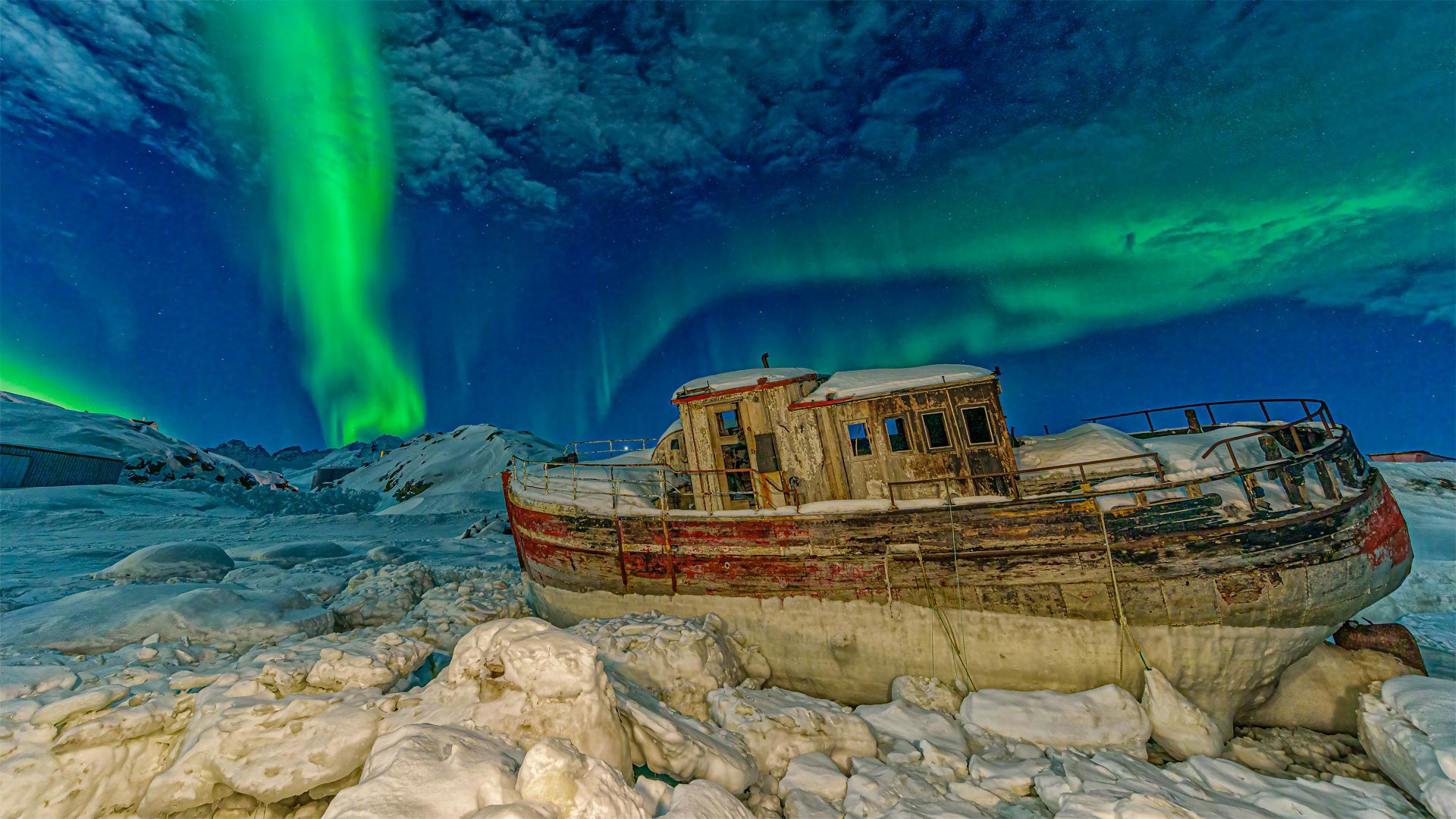 Northern lights over a stranded boat in Tasiilaq, Greenland - Shane P. White
