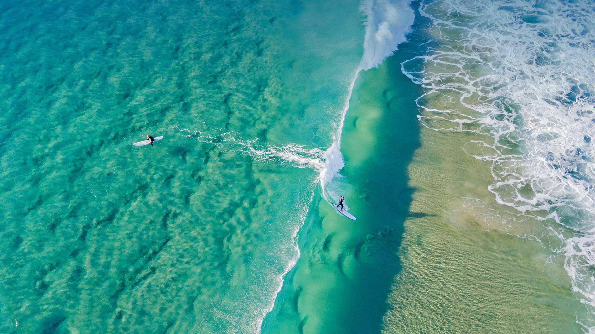 Surfers catching waves at Palm Beach on the Gold Coast, Queensland, Australia - Darren Tierney/Getty Images)