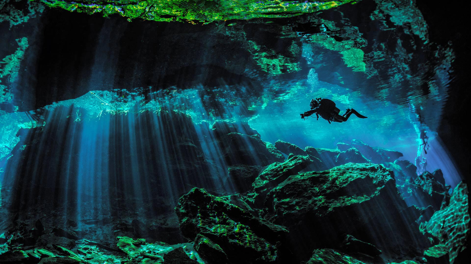 Scuba diver exploring the underwater cenotes near Puerto Aventuras, Mexico - Extreme Photographer/Getty Images)