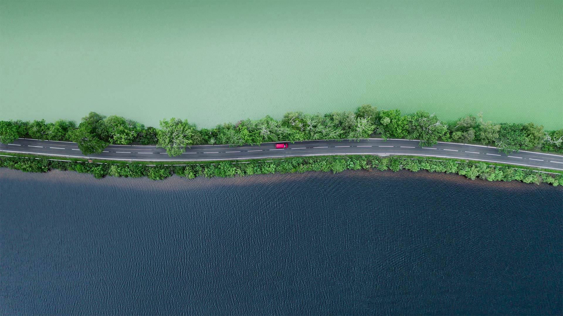 Aerial view of a road separating two lakes in the Scottish Highlands - Abstract Aerial Art/Getty Images)
