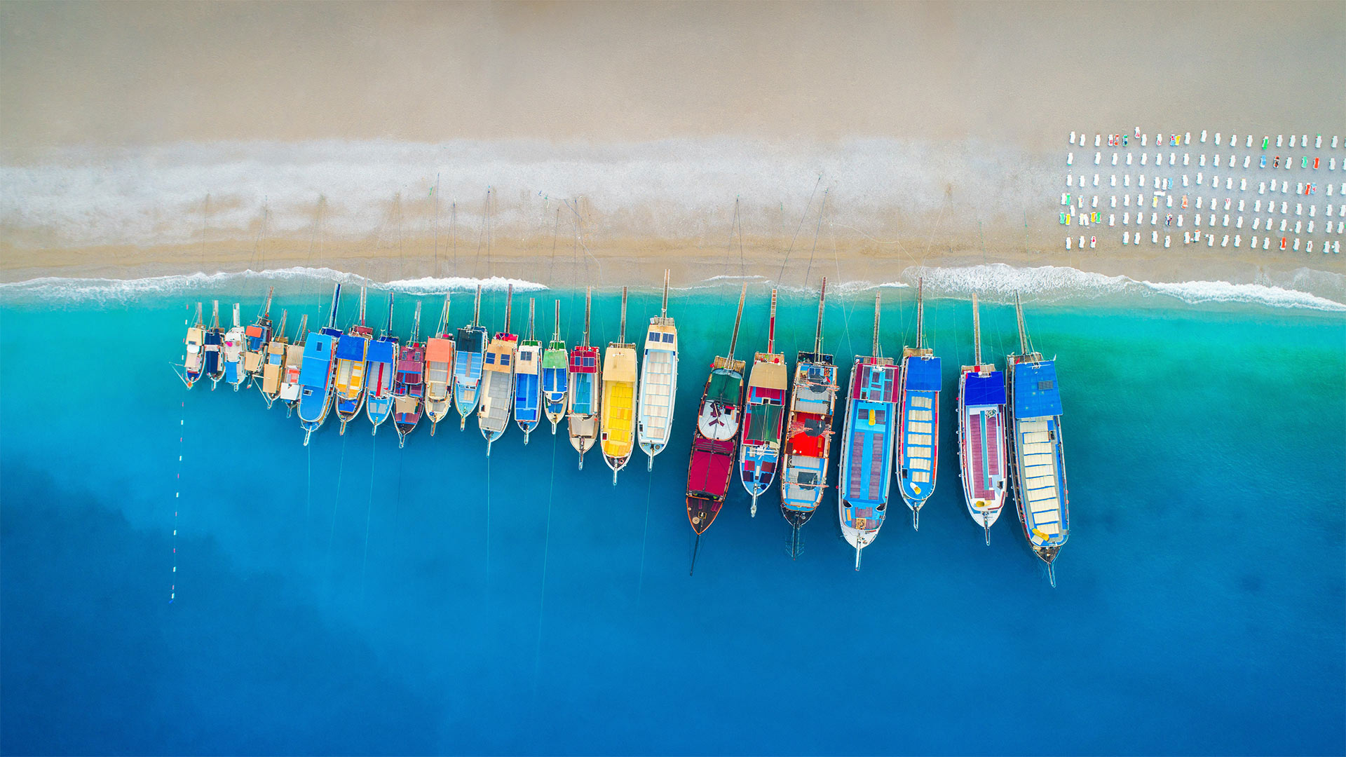 Aerial view of colorful boats in the Mediterranean Sea in Ölüdeniz, Turkey - den-belitsky/Getty Images)
