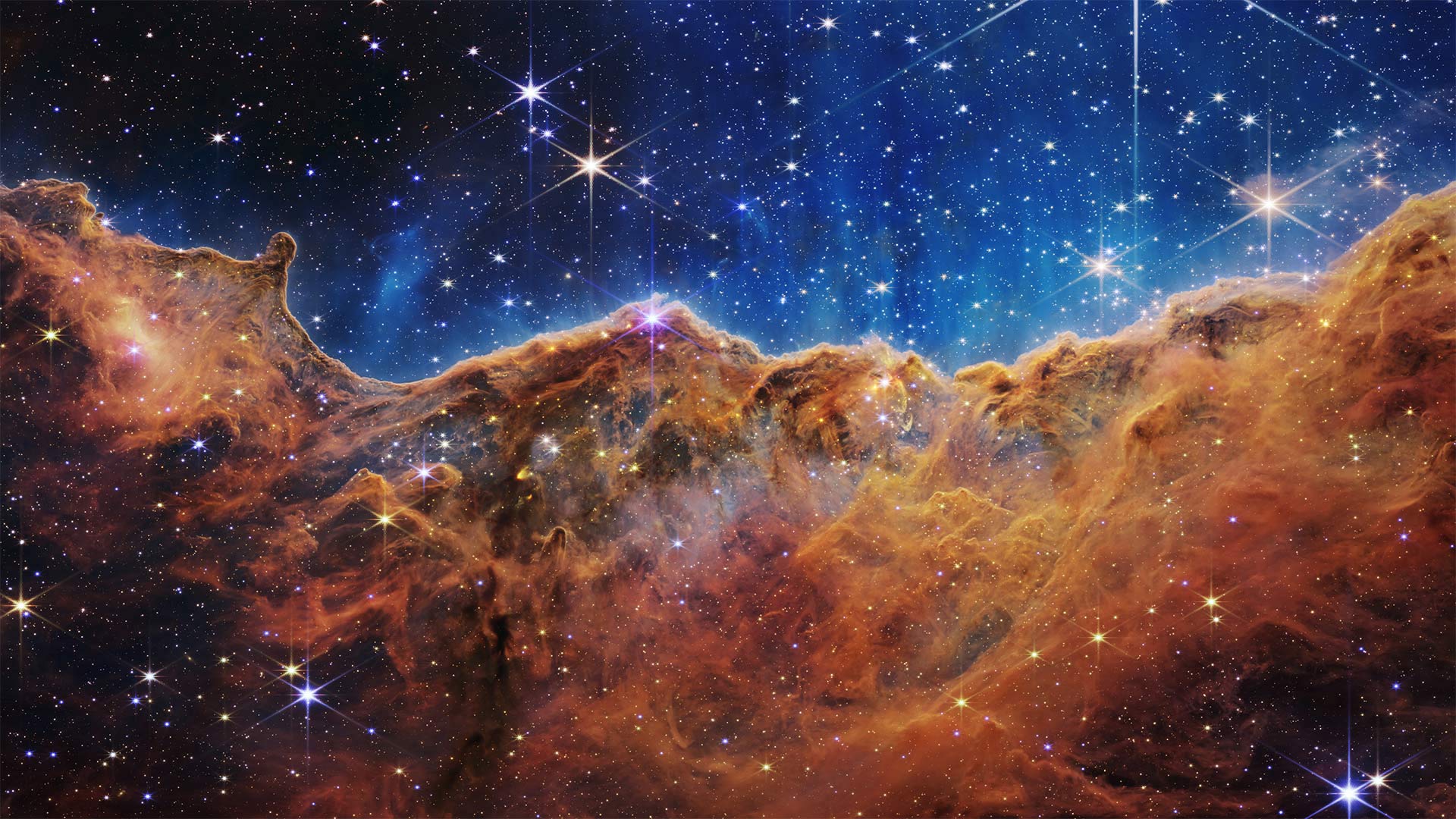 Cosmic Cliffs in the Carina Nebula - NASA, ESA, CSA, and STScI)