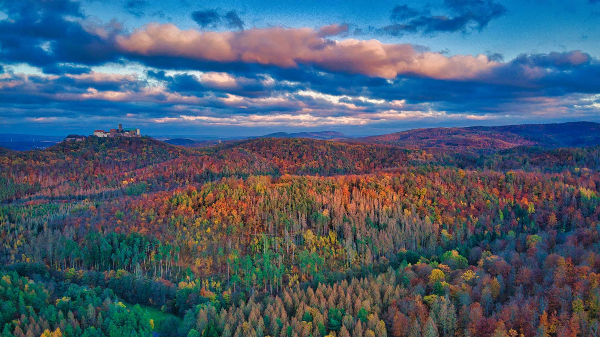 Thuringian Forest in autumn with Wartburg Castle, Germany - ezypix/Getty Images)