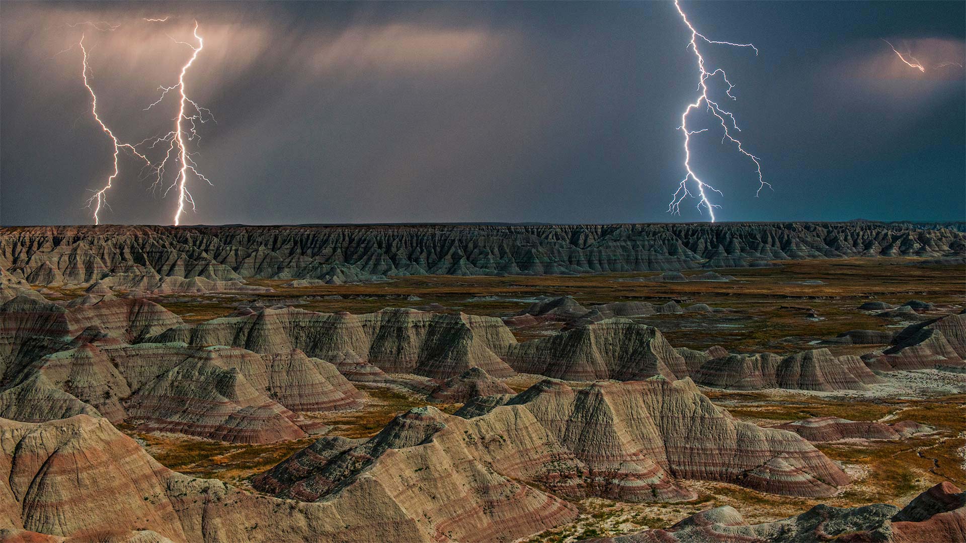 Rock formations in Badlands National Park during a lightning storm, South Dakota - DEEPOL by plainpicture)