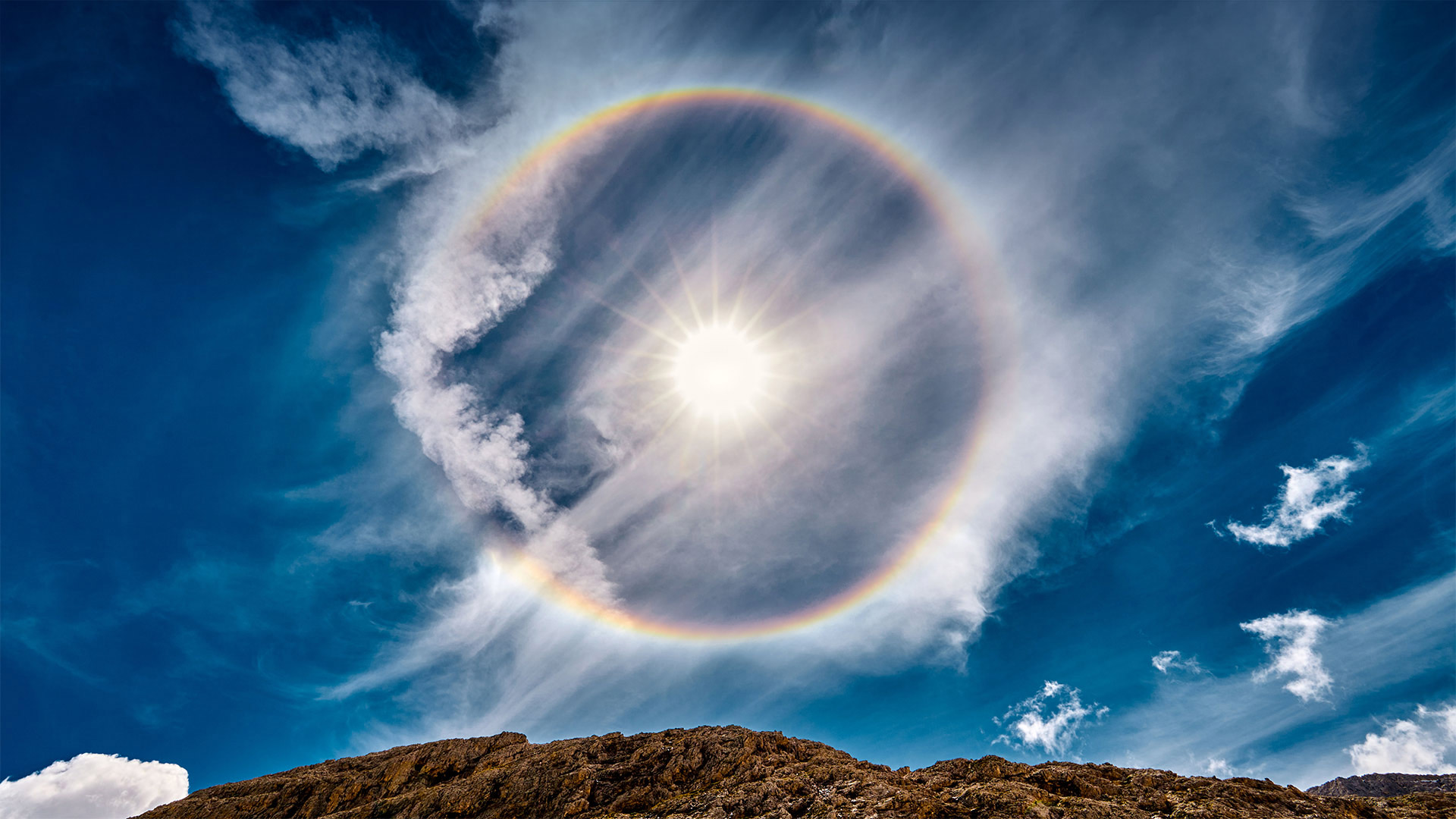 Sun halo over Lake Antermoia in the Dolomite Mountains of Italy - Walter Donega/Getty Images)