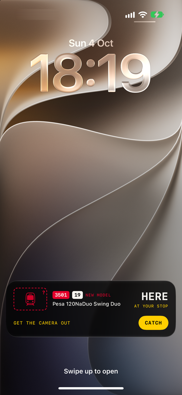 The Lock Screen with TABOR's Live Activity: #3501, line 19, NEW MODEL, Pesa 120NaDuo Swing Duo, HERE · AT YOUR STOP, GET THE CAMERA OUT and a CATCH button.