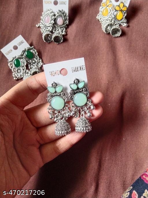 These stunning oxidized silver jhumkas feature vibrant red, green, and pink hues, perfect for festive occasions. Their intricate designs complement any outfit, adding a touch of elegance and tradition, making them an ideal accessory for celebrating in style - Akhilo.com