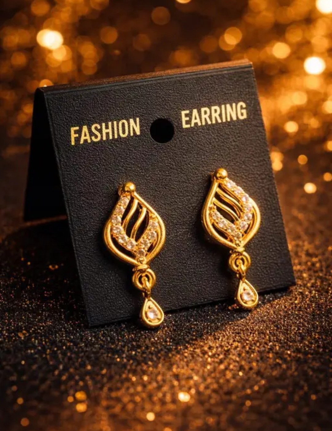 A graceful teardrop or leaf-like pattern with intricate cut-outs and a small hanging drop at the bottom. ( Micro E-12 )