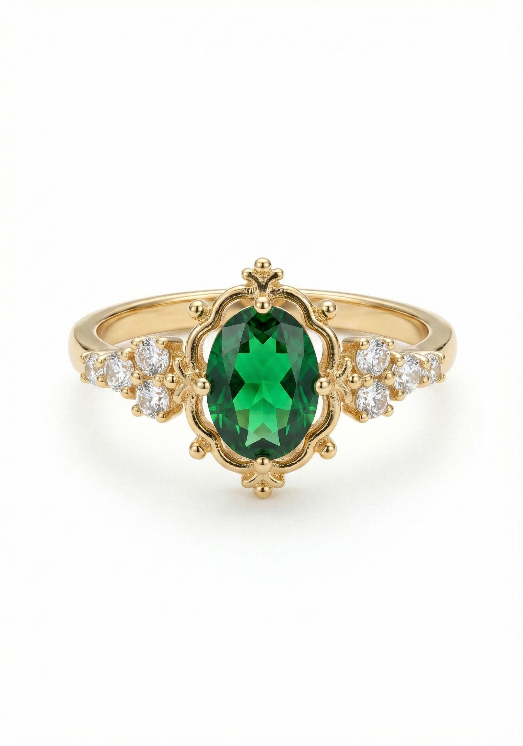 Prsten ve zlatém lesku s broušenými krystaly v tónu emeraldu