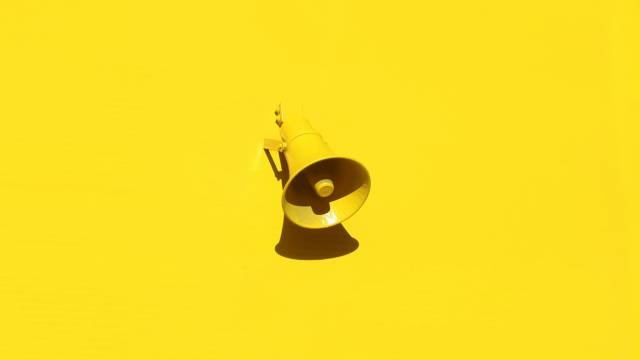 yellow loudspeaker